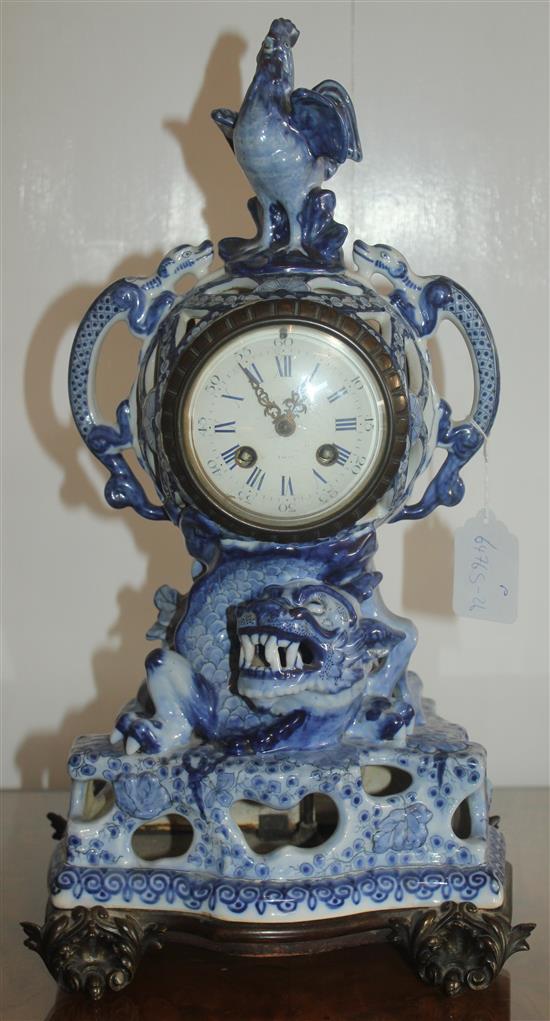 A 19th century French faience clock garniture, clock 18in.